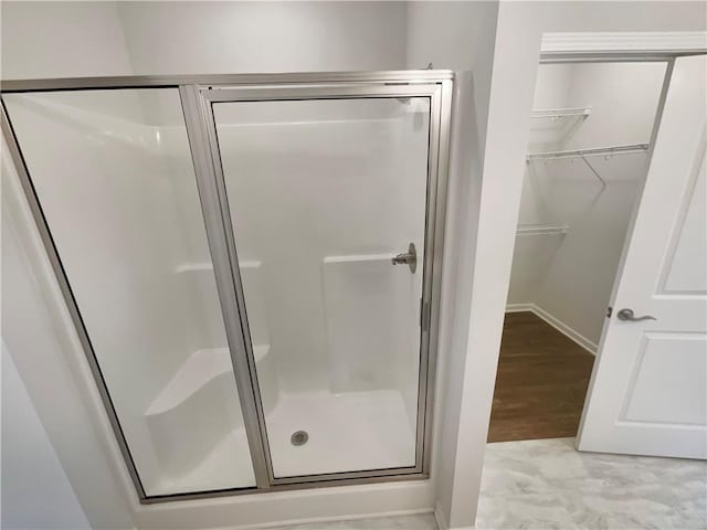 bathroom featuring a shower with door