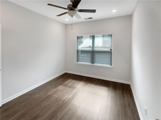 unfurnished room featuring ceiling fan and dark wood-type flooring