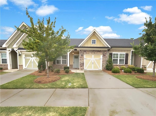 craftsman-style house featuring a front lawn and a garage