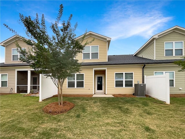 view of front of house featuring central AC and a front lawn