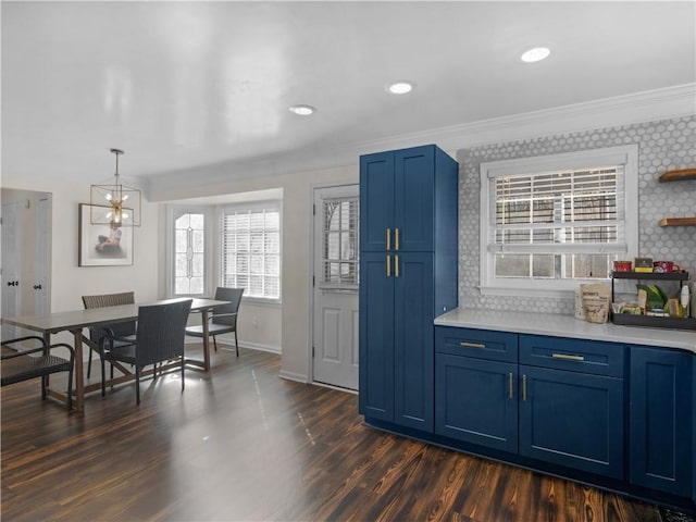 kitchen featuring tasteful backsplash, light countertops, dark wood finished floors, and blue cabinetry