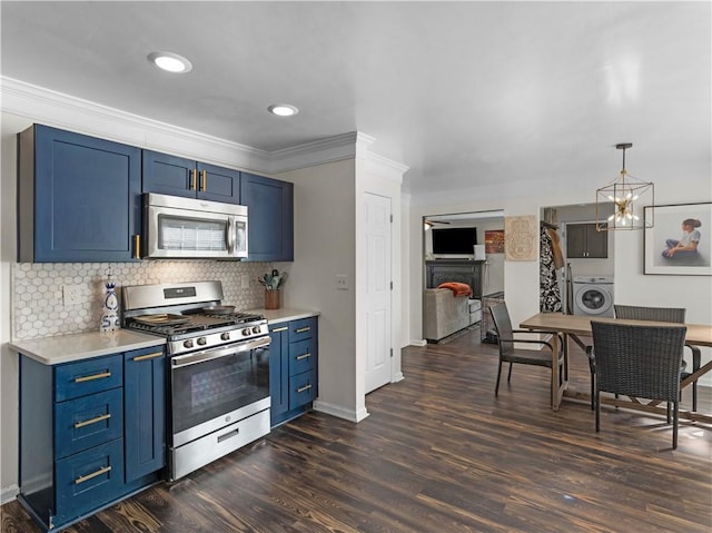 kitchen with stainless steel appliances, washer / clothes dryer, light countertops, and blue cabinetry