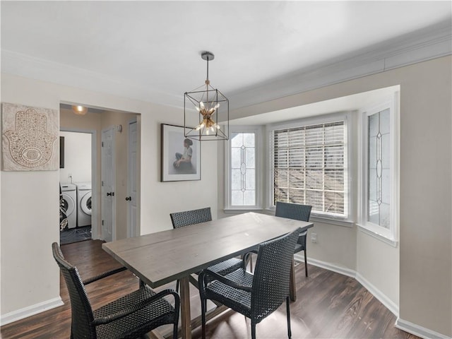 dining space featuring washing machine and dryer, baseboards, and dark wood-type flooring