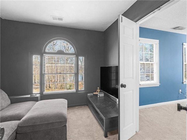 interior space with carpet floors, visible vents, and baseboards