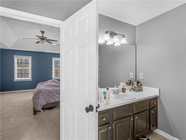 bathroom featuring ceiling fan, baseboards, and vanity