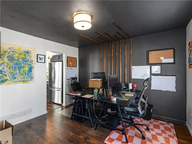 office featuring visible vents, baseboards, and wood finished floors