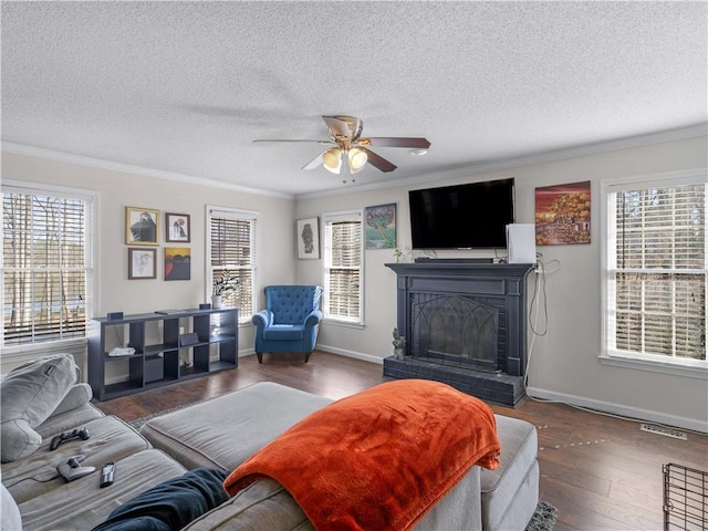 living room with ornamental molding, wood-type flooring, and a fireplace