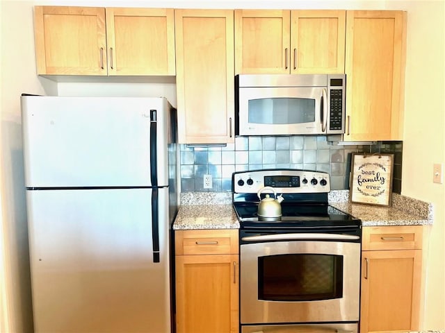 kitchen with light brown cabinets, tasteful backsplash, and appliances with stainless steel finishes