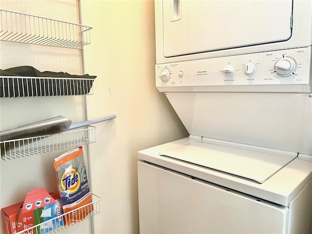 laundry room with stacked washer and clothes dryer and laundry area