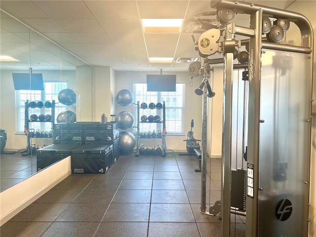 gym with a paneled ceiling