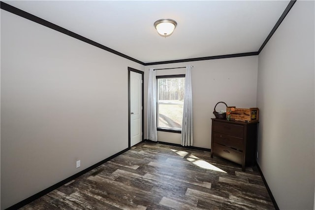 interior space with ornamental molding, wood finished floors, and baseboards