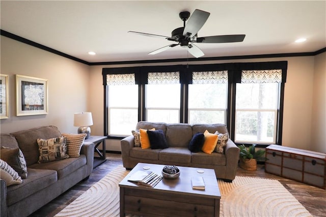 living area featuring recessed lighting, wood finished floors, a wealth of natural light, and crown molding