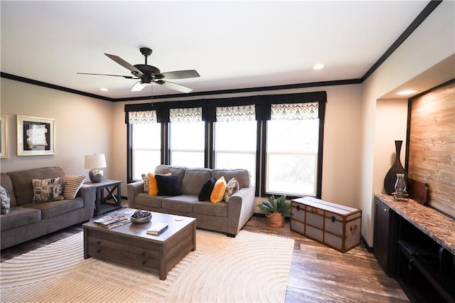 living room featuring recessed lighting, a ceiling fan, crown molding, and wood finished floors