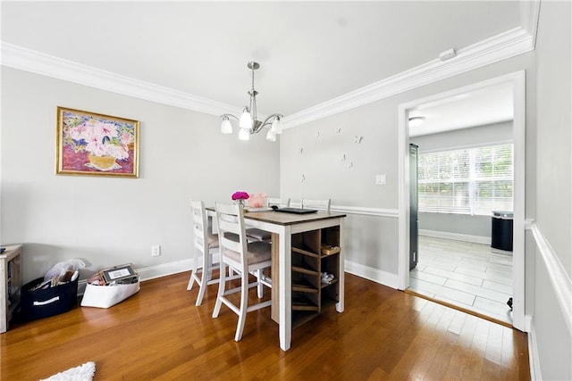 6980 Roswell Rd # A8, Atlanta, GA 30328 - dining room with a chandelier, crown molding, wood-type flooring, and baseboards