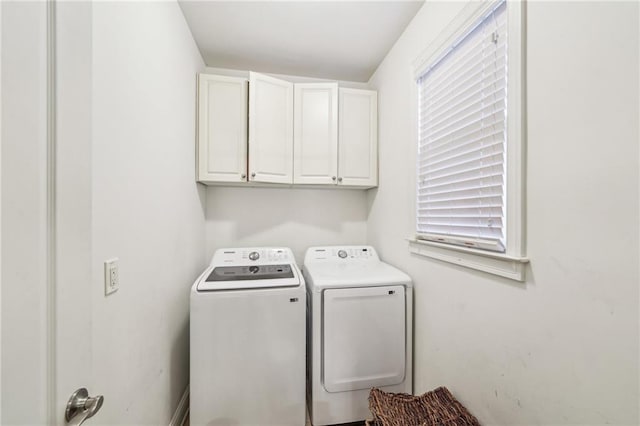 laundry room with cabinets and washing machine and clothes dryer