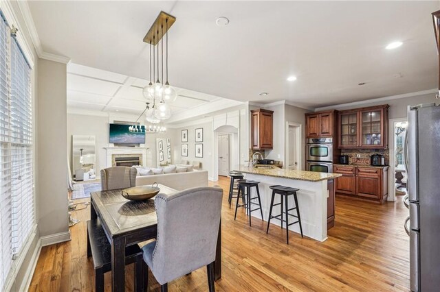 bedroom featuring a raised ceiling, ceiling fan, crown molding, and carpet