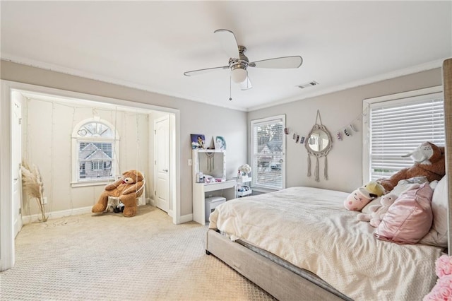 carpeted bedroom featuring ceiling fan and ornamental molding