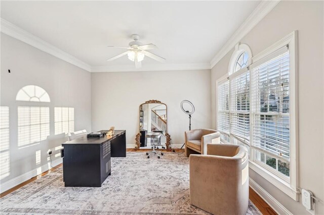 bedroom featuring ceiling fan, crown molding, light carpet, and multiple windows