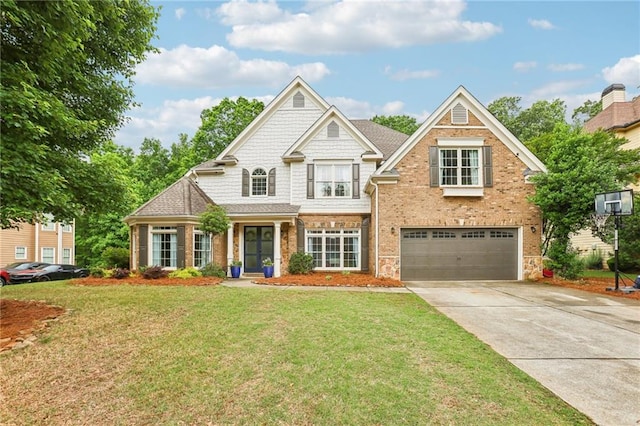 view of front facade featuring an attached garage, driveway, a front yard, and brick siding