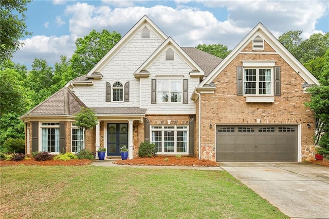 view of front of property with an attached garage, a front yard, driveway, french doors, and roof with shingles