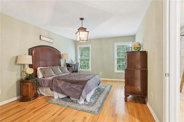 bedroom featuring wood finished floors and baseboards