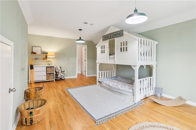 bedroom featuring wood finished floors and baseboards