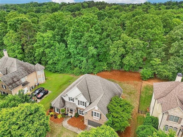 view of subject property with a heavily wooded area