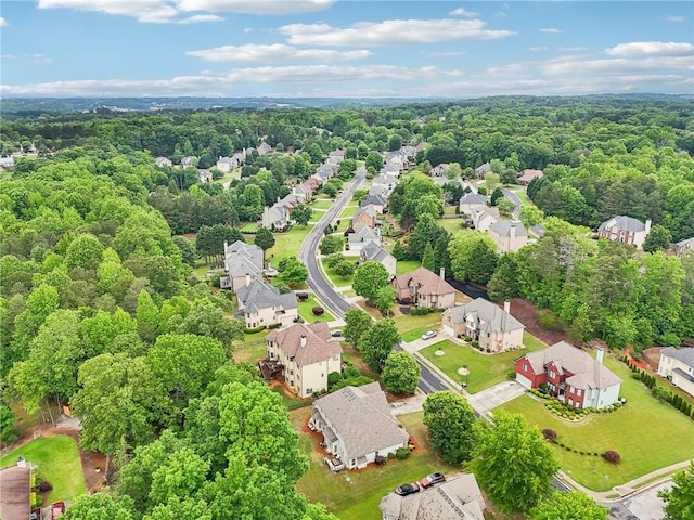 aerial view of residential area with a heavily wooded area