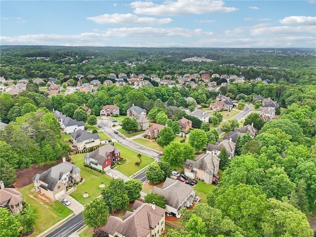 aerial perspective of suburban area with a heavily wooded area
