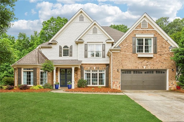 view of front of property featuring an attached garage, a front yard, driveway, french doors, and a shingled roof