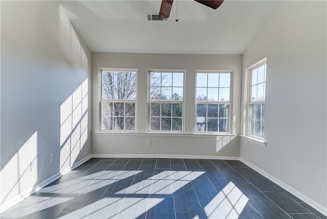 unfurnished sunroom with ceiling fan