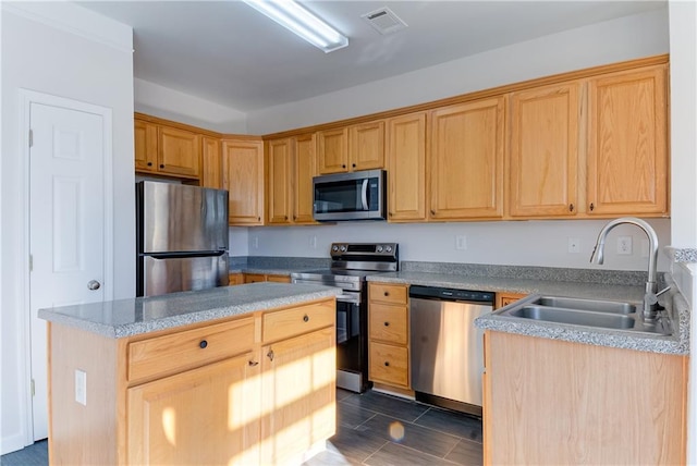 kitchen featuring sink, a center island, and stainless steel appliances