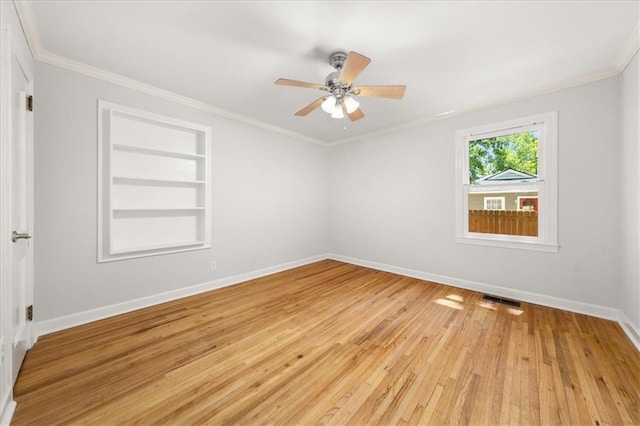 2272 Desmond Dr, Decatur, GA 30033 - empty room featuring ornamental molding, baseboards, light wood-style floors, ceiling fan, and built in features
