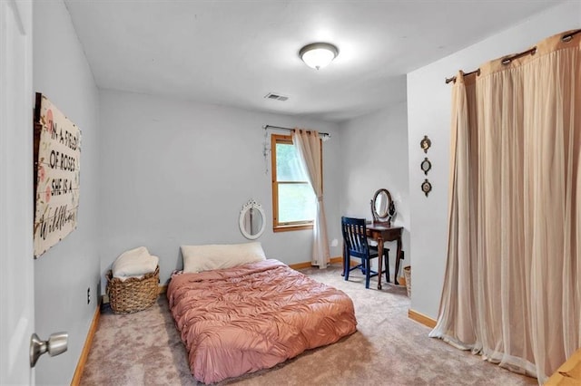 bedroom featuring carpet floors and baseboards