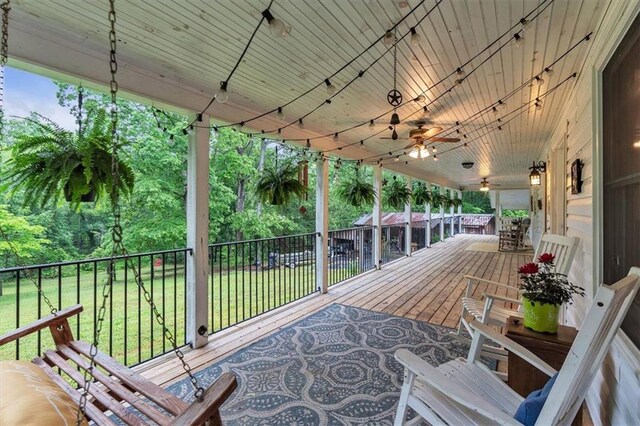 deck with ceiling fan and a yard