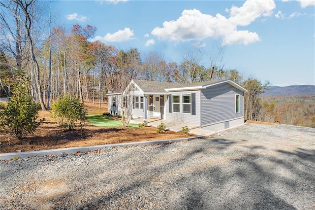 view of front of home featuring a mountain view and a porch