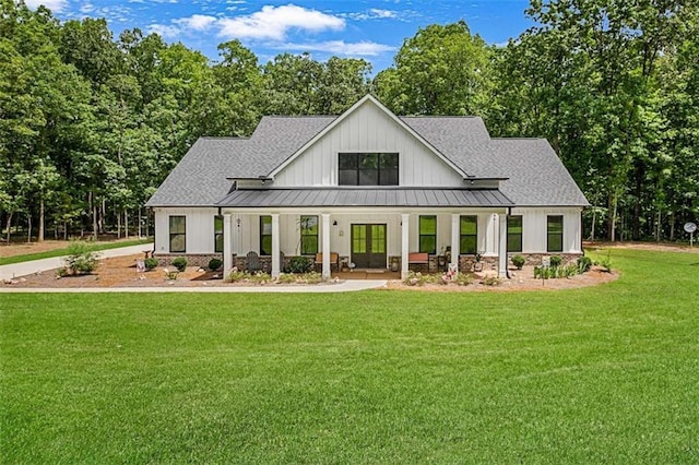 1505 Willis Rd, Barnesville, GA 30204 - back of house featuring a standing seam roof, covered porch, roof with shingles, and a lawn