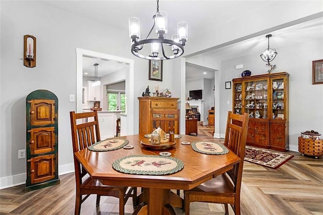 1505 Willis Rd, Barnesville, GA 30204 - dining area with a chandelier and a lit fireplace
