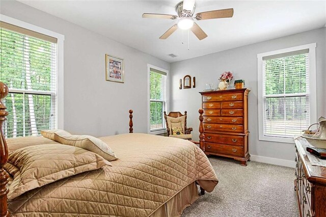 1505 Willis Rd, Barnesville, GA 30204 - bedroom with light colored carpet, multiple windows, and a ceiling fan