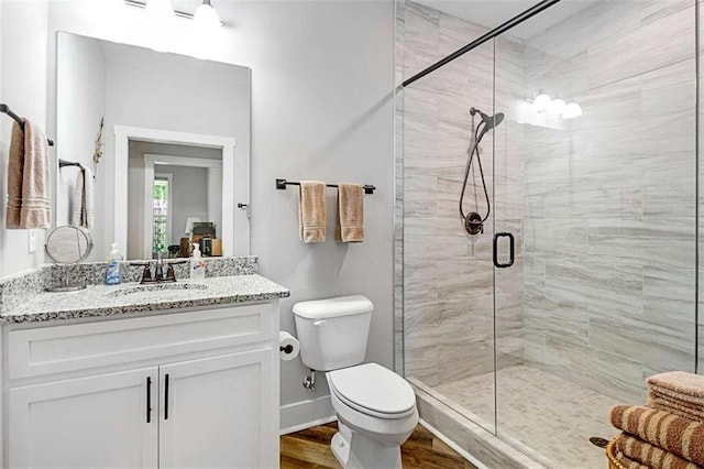 1505 Willis Rd, Barnesville, GA 30204 - full bathroom featuring vanity, a shower stall, and wood finished floors