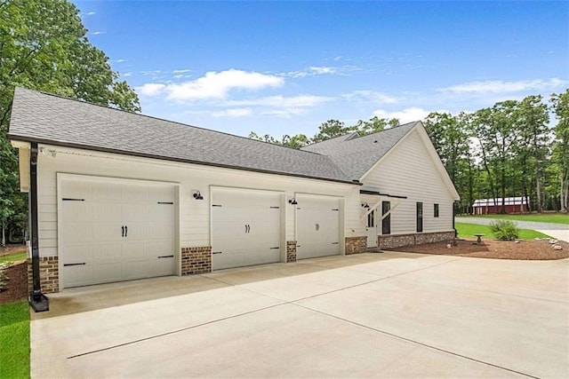 1505 Willis Rd, Barnesville, GA 30204 - view of property exterior with driveway, brick siding, a garage, and roof with shingles