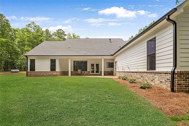 1505 Willis Rd, Barnesville, GA 30204 - back of property with brick siding, french doors, and a lawn