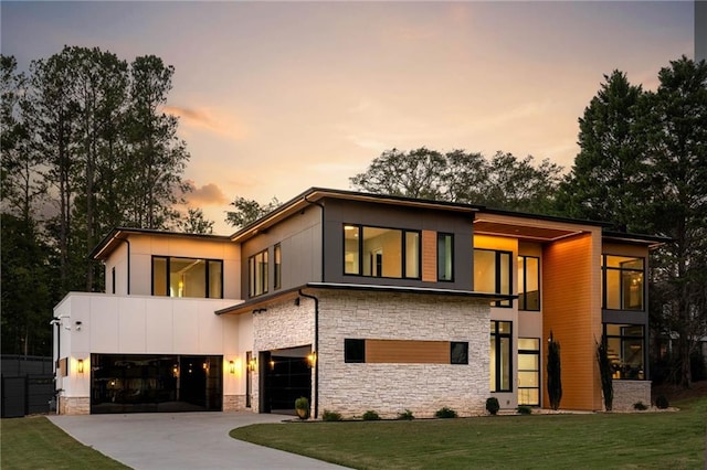 view of front of house with a garage and a lawn