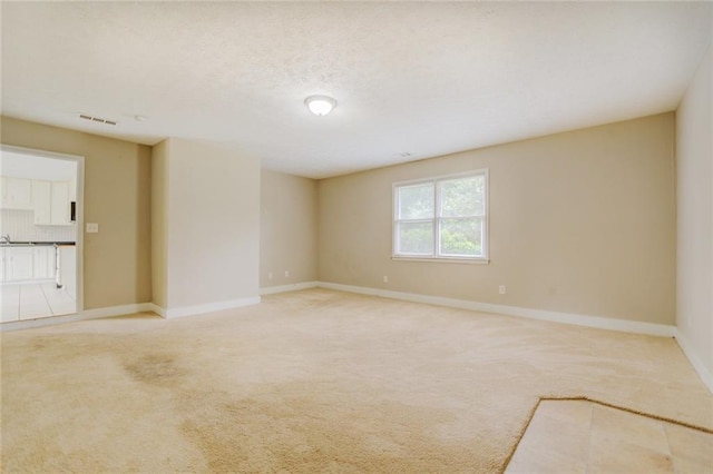 spare room featuring light colored carpet