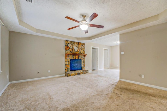 1187 Dixie Rd, Covington, GA 30014 - unfurnished living room featuring carpet, ceiling fan, a textured ceiling, a stone fireplace, and baseboards