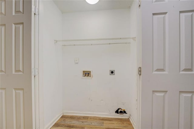 clothes washing area featuring hookup for an electric dryer, hookup for a washing machine, and light hardwood / wood-style flooring