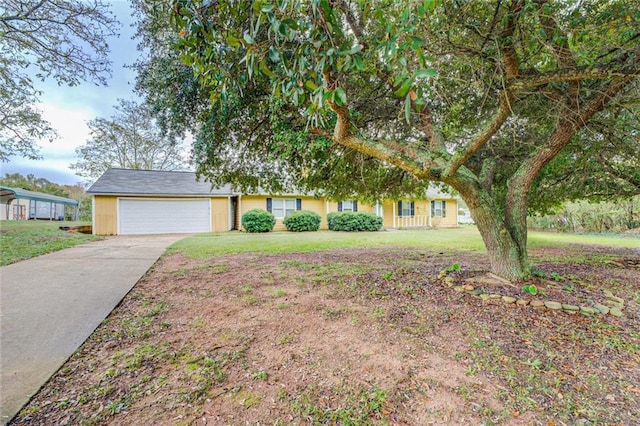 1187 Dixie Rd, Covington, GA 30014 - view of front of house with concrete driveway, a front yard, and a garage
