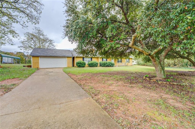 1187 Dixie Rd, Covington, GA 30014 - view of front facade featuring driveway, an attached garage, and a front yard