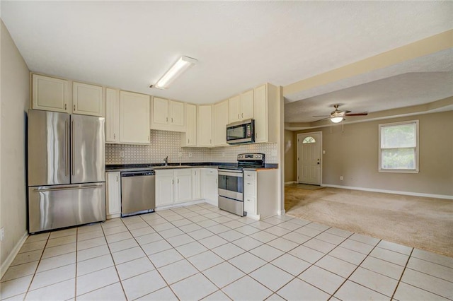 1187 Dixie Rd, Covington, GA 30014 - kitchen featuring stainless steel appliances, baseboards, open floor plan, tasteful backsplash, and ceiling fan