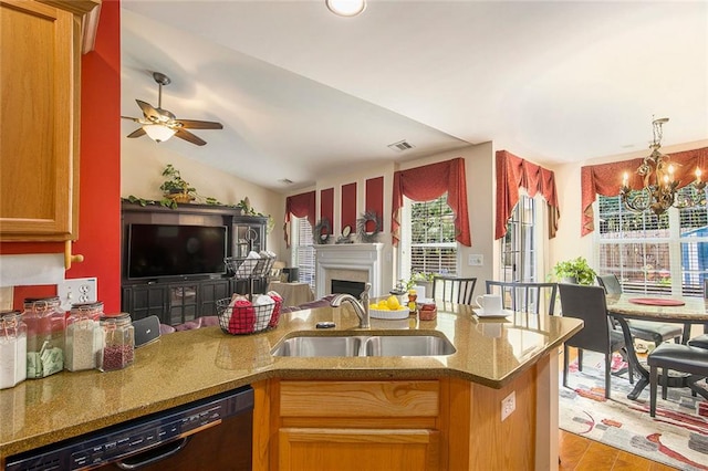3198 Liberty Commons Dr, Kennesaw, GA 30144 - kitchen with dishwasher, open floor plan, stone countertops, a chandelier, and a fireplace